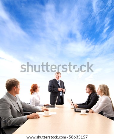 Business group of two young ladies, two young men and a mature boss at work isolated on white