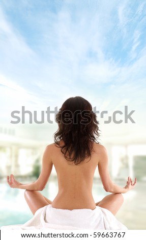 Young fit brunette meditating isolated on white
