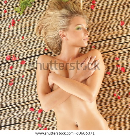 Attractive woman getting spa treatment in exotic atmosphere