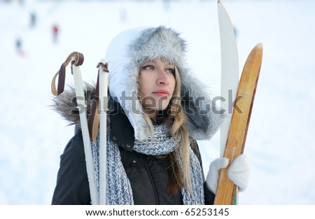 woman with ski over winter background