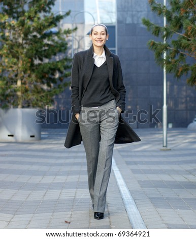 Business woman walking in the park