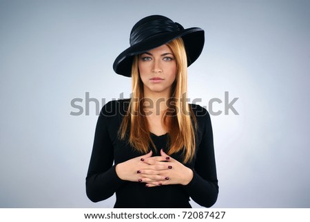 Young attractive widow over grey background