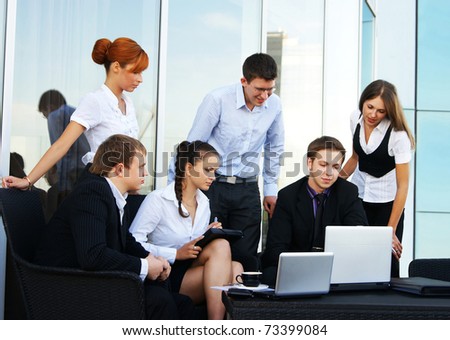 Business group of many different people in office at work