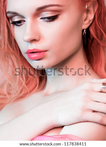 fashion model close-up face art women in color clothes portrait on color background long light pink hair