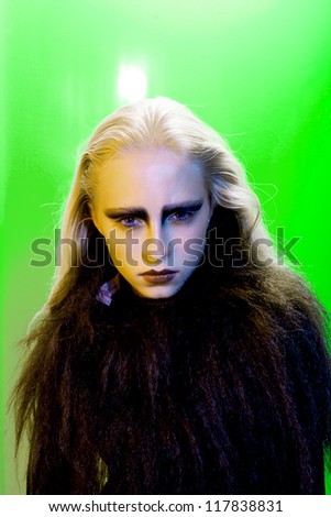 fashion model close-up portrait on color background in black clothes long dark hair