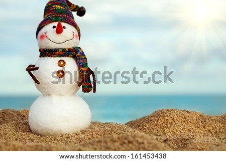 Smiling snowman on the sea beach. Holiday concept can be used for New Year and Christmas Cards