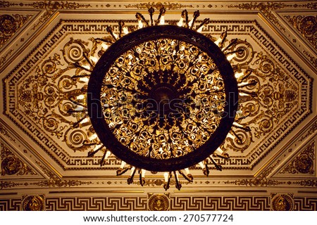 Chandelier hanging under a ceiling in a palace