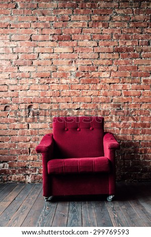 relax red armchair against red brick wall