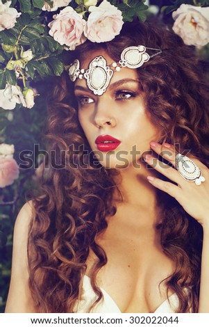portrait of a beautiful brunet with accessories in the summer garden