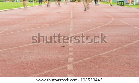 Running track with running legs in sport shorts and jogging shoes