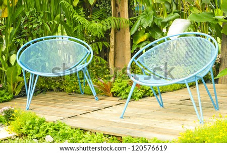 Blue lawn chairs in the summer garden.