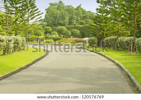 road and beautiful Lush Green Topiary garden