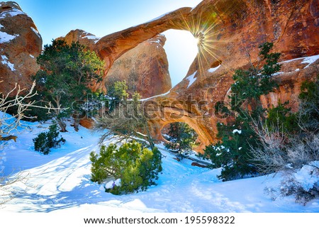 Sun rays coming through the Double-O-Arch in Devil's Garden in Arches National Park, Utah in winter, HDR