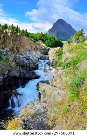 waterfall and alpine scenery of the Glacier National Park in summer