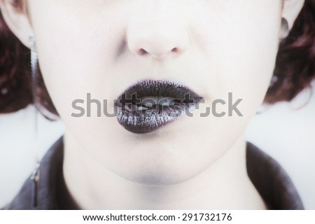 beautiful make up of glamour black gloss lips of a young woman