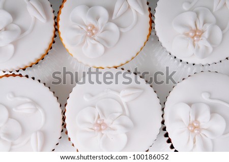 six white wedding cupcakes