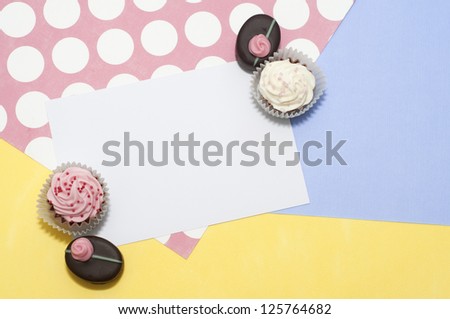 Spring card design with rose bonbons and chocolate mini cupcakes