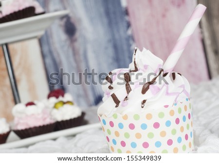 Cupcake strawberry chocolate swirl with straw