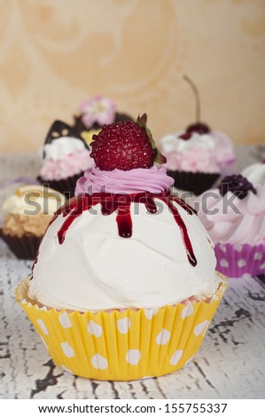 Strawberry cupcake with baby cupcakes in the background