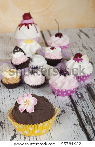 loads of cupcake with fruit and flower decoration