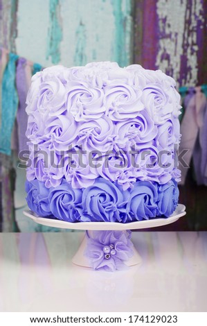 Purple Wedding Cake On A Cake Stand With Flower Decoration