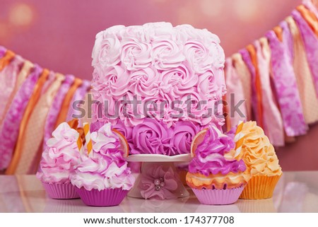 Beautiful party table with cake and cupcakes