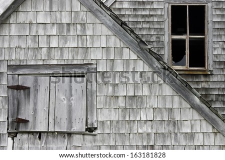 Abandoned old weathered wood shingled building in Maine.