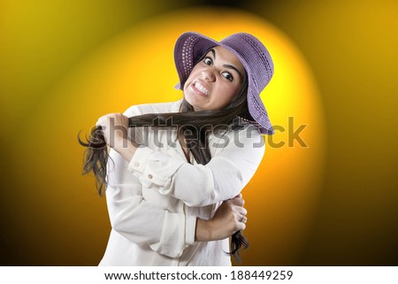 Cute girl wearing a purple hat and face annoying long hair is pulled in frustration