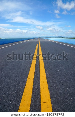 Blue sky with could,  Empty road and the traffic lines.