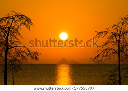 Sunset sky and big sun over the lake.