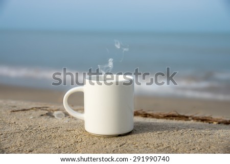 White coffee mug on the beach.