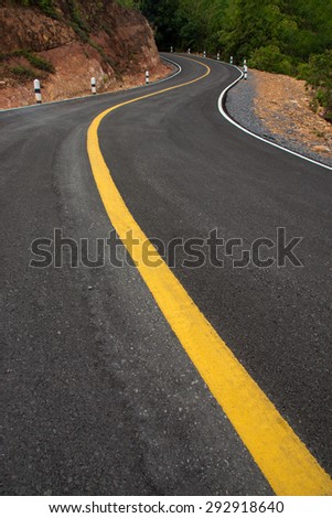 The road curved empty
