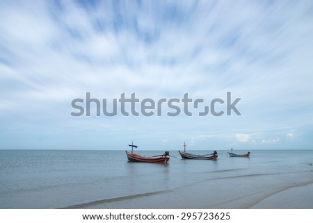 Fishing boats on the Quiet sea and motion cloud, Thailand.