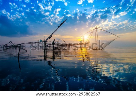 Silhouette of bamboo machinery in the lake. South of Thailand.