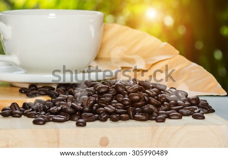 Roasted  coffee beans on the wood with light