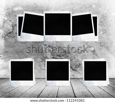 Blank photo frames on aged wall