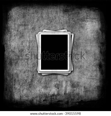 Old fashioned blank photo frames on grunge background