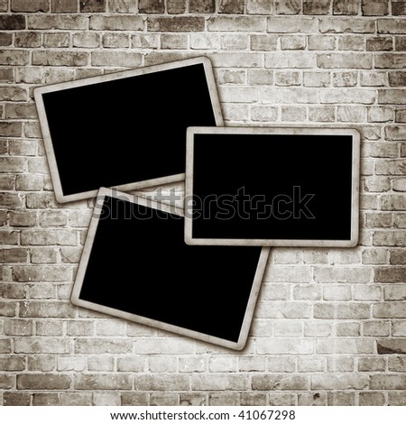 Blank photo frames on wall background