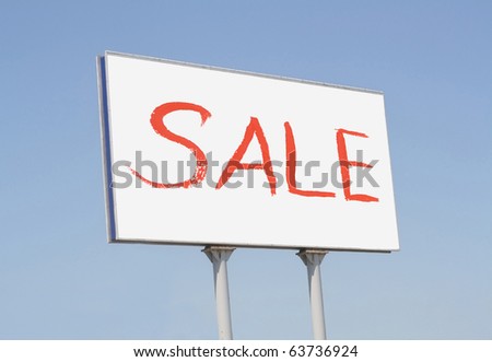 Outdoor billboard with sale sign against blue sky