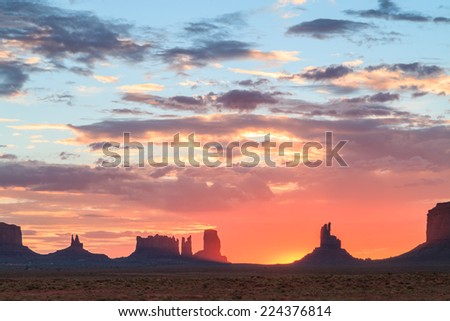 Sun rising above horizon at Monument Valley Navajo Tribal Park