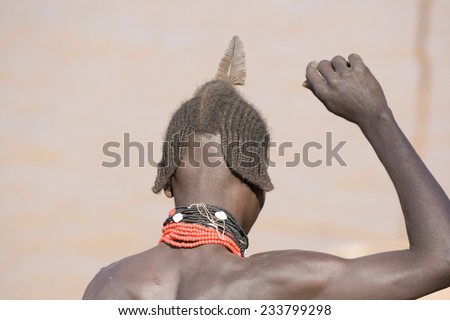 TURMI, ETHIOPIA - DECEMBER 28, 2008: Typical hairstyle of men of the ethnic Hamer-Banna group close to the river on December 28, 2008 near Turmi, Ethiopia.