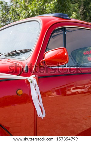 Details of a red and shiny vintage beetle car