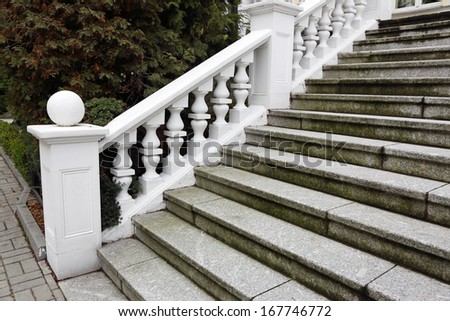 staircase with white plaster railings