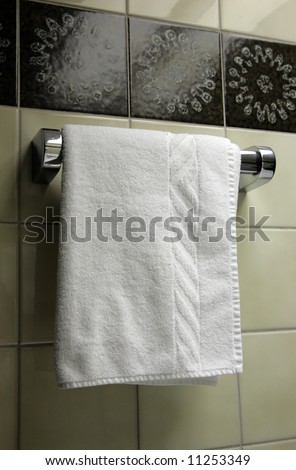The towel hangs on a hanger in a bathroom
