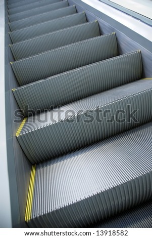 Steps of the moving escalator without people