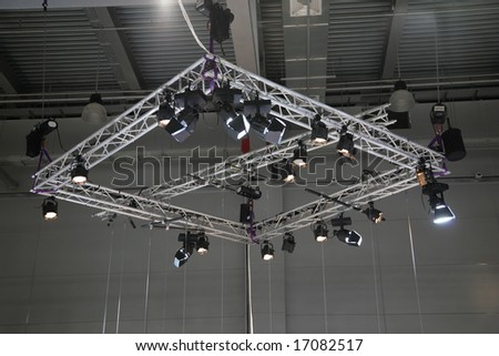 Projectors on a stage under a ceiling