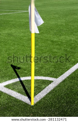 Flag on the corner of football field with shadow at sunny day