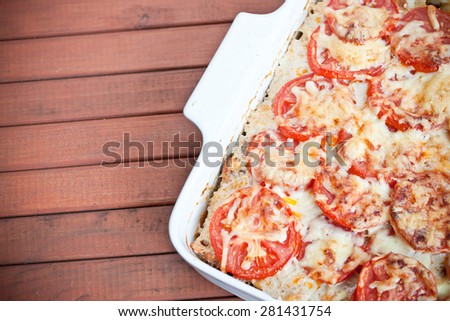 Delicious pie with tomato and grated cheese coating