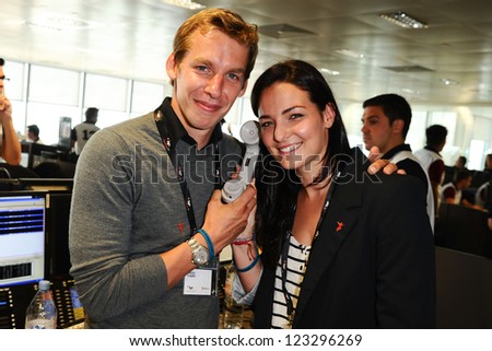 Olympic open water swimmers, Keri-Anne Payne and Dave Carry on the trading floor of BGC as part of the BGC Charity Day 2012, Canary Wharf, London. 11/09/2012 Picture by: Steve Vas