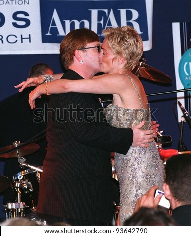 21MAY98:  Actress SHARON STONE & pop star SIR ELTON JOHN kiss after performing for charity at AmFAR\'s Cinema Against AIDS gala at Moulin de Mougins, France.